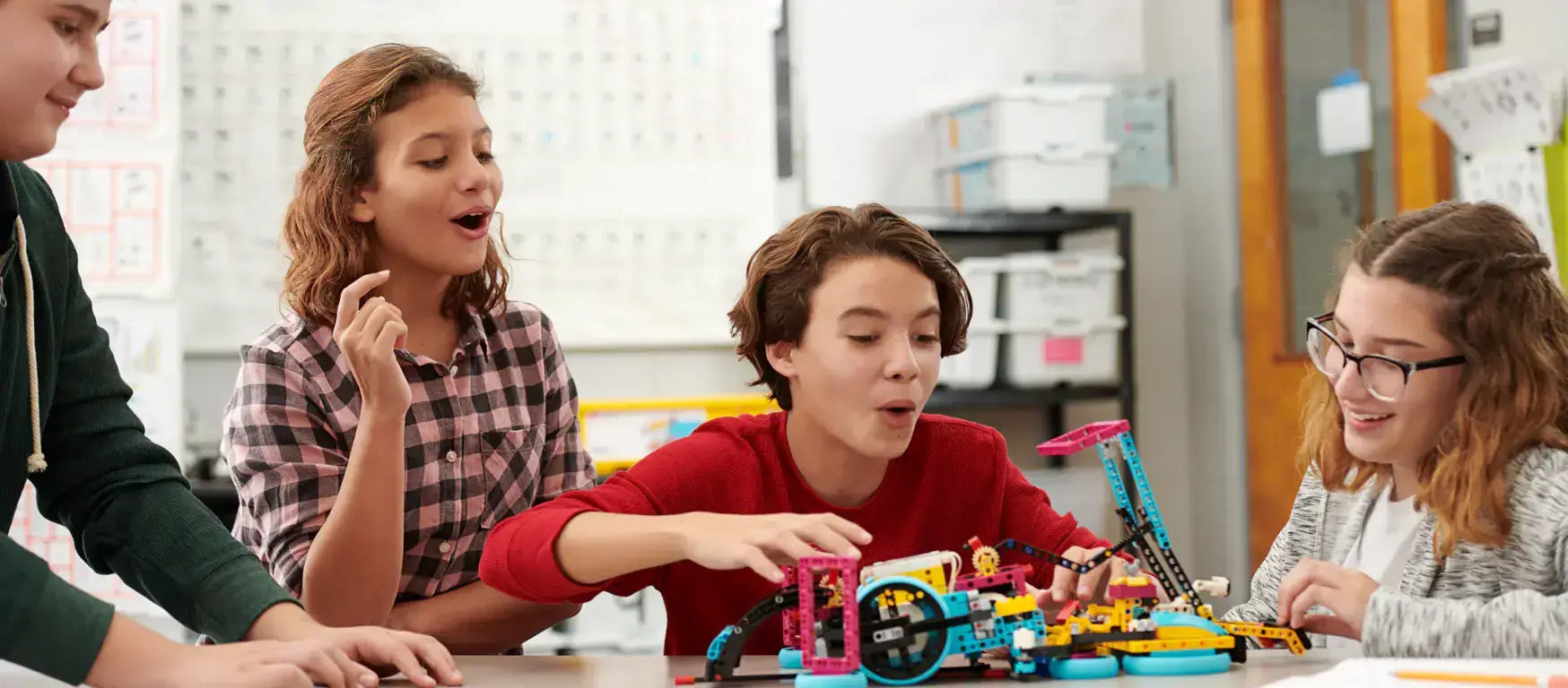 Students excitedly engaging with LEGO Education SPIKE Prime kit during a hands-on STEAM activity.