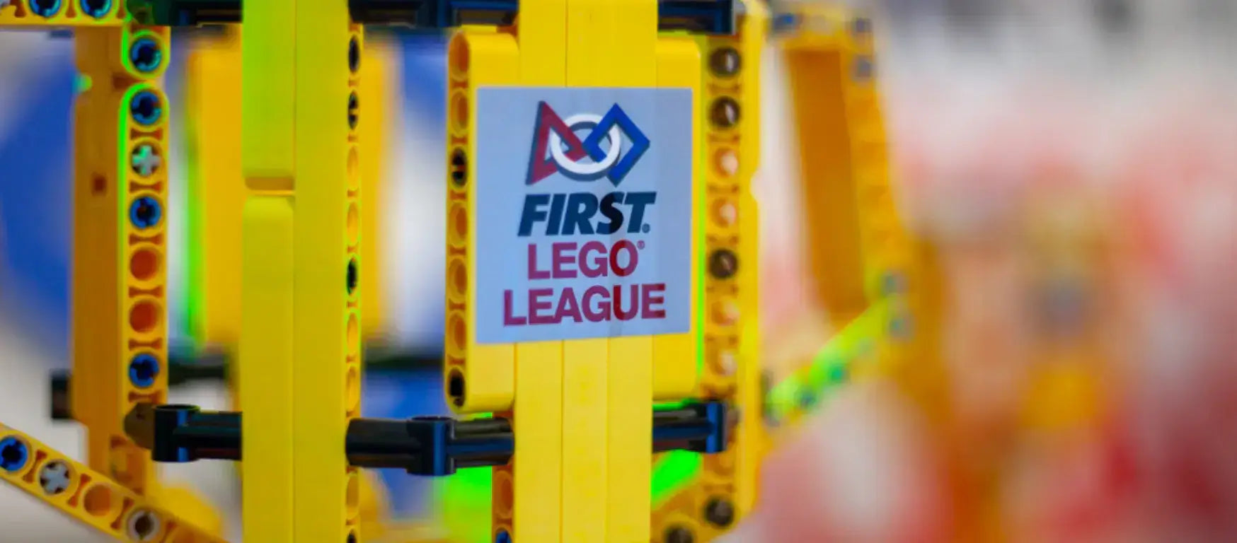 FIRST LEGO League logo featured on a colorful robotics structure at the UK National Finals in Harrogate.
