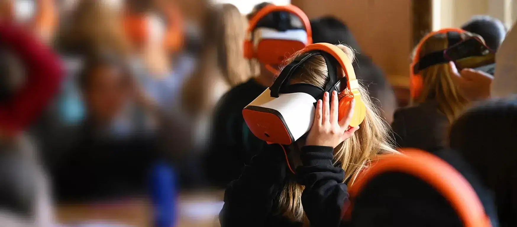 Students engaged with virtual reality headsets in a classroom setting, enhancing the learning experience.