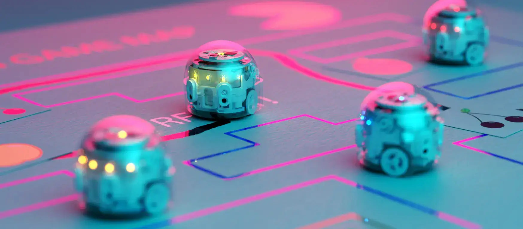 Colorful Ozobots navigating a game map, showcasing interactive coding in the classroom.