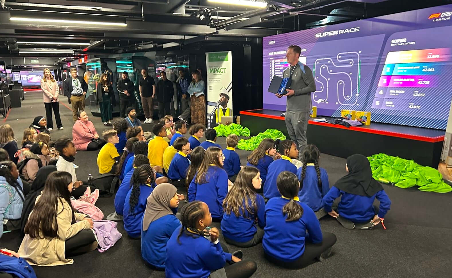 Students engaged in a STEM initiative session with Schneider Electric at Tottenham Hotspur Foundation, learning about technology.