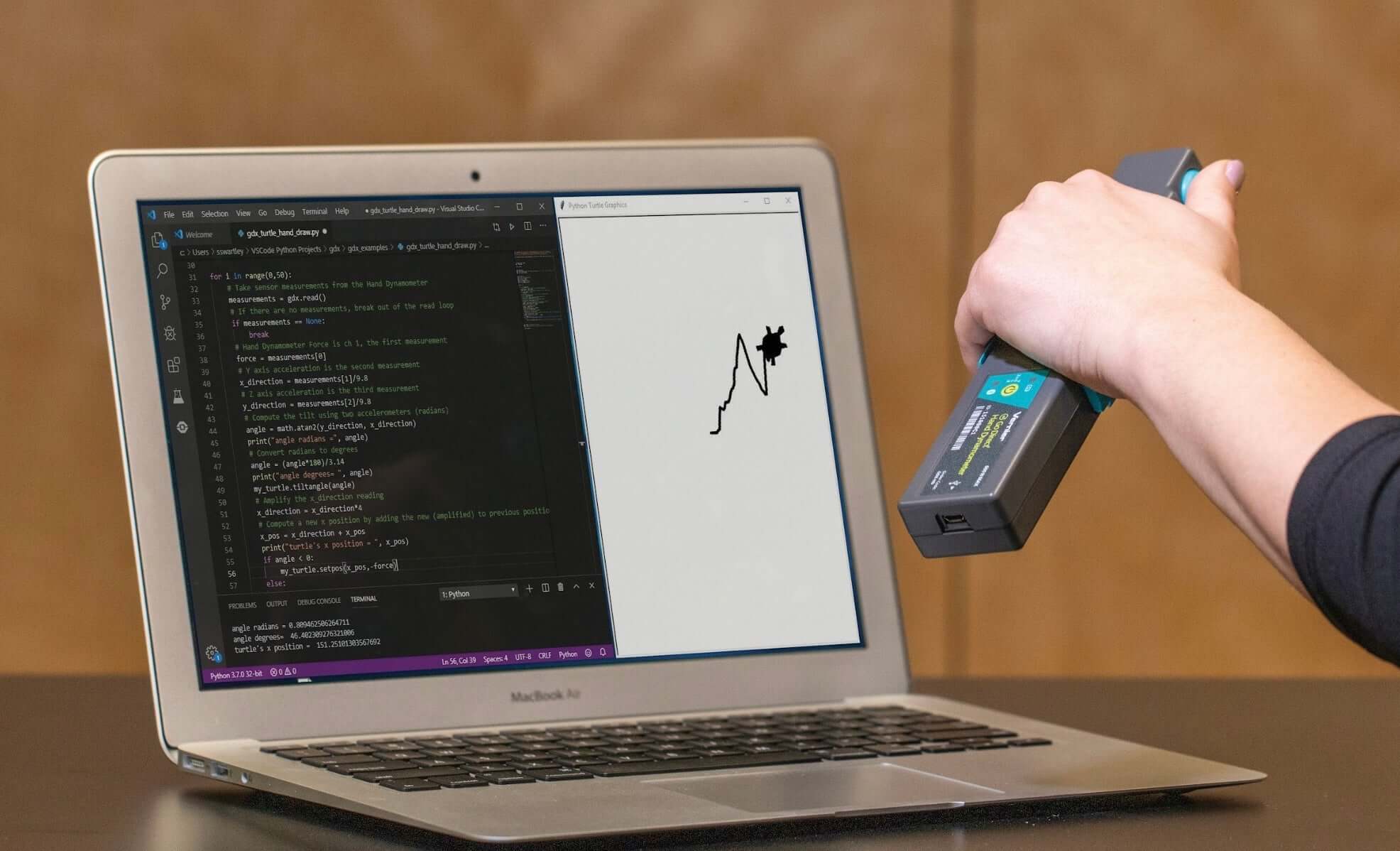 Person using a Vernier device to analyze data on a laptop, showcasing technology integration in education.