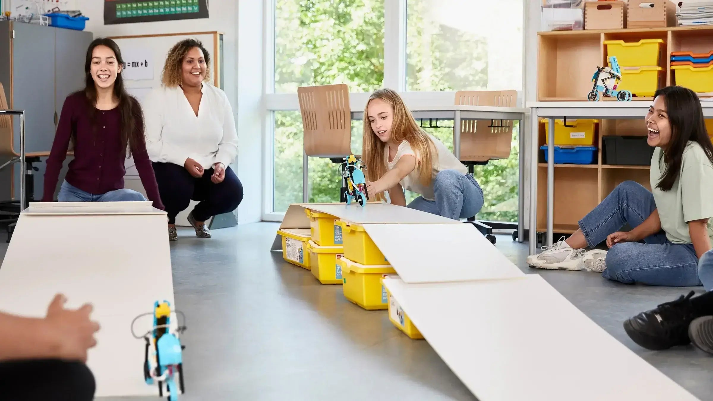 Students engaged in hands-on LEGO Education robotics activity in a classroom setting.