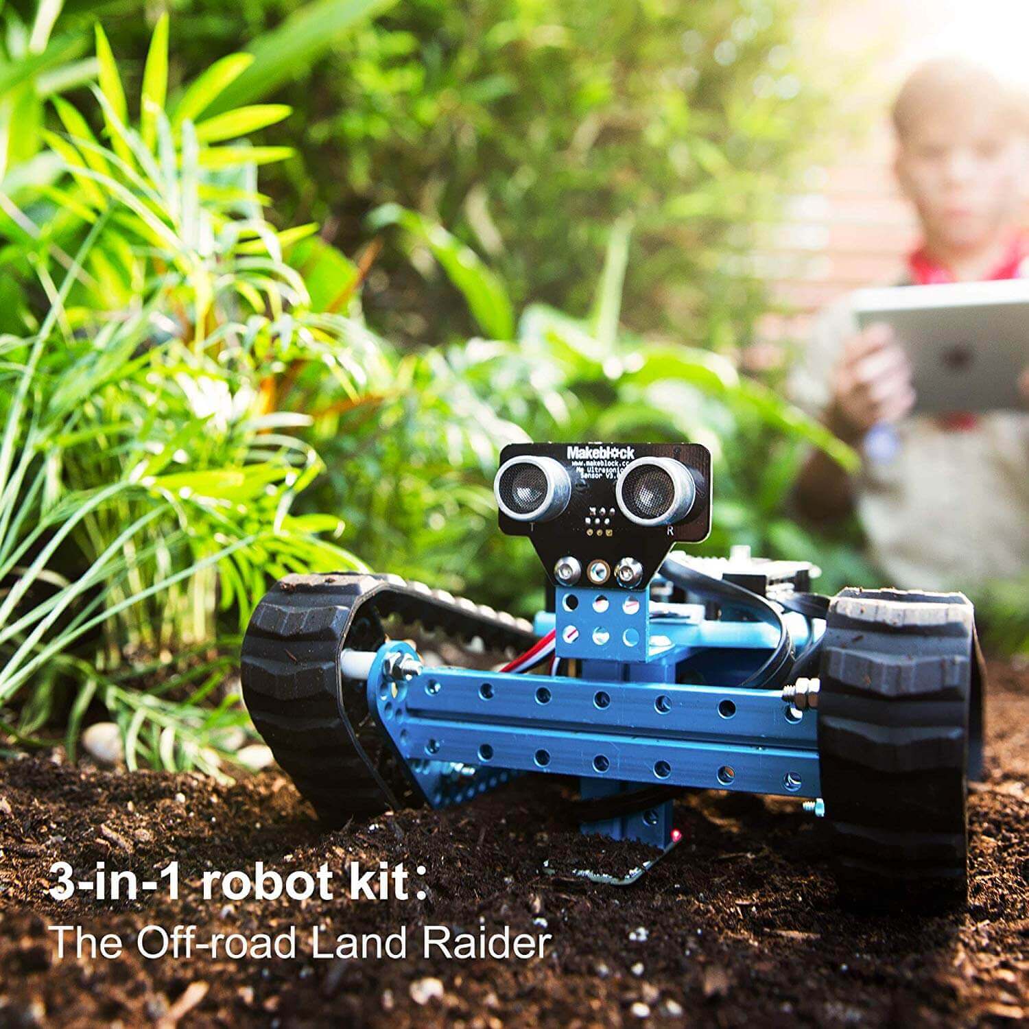 Makeblock mBot Ranger Land Raider robot kit in a garden, showcasing its off-road design and Bluetooth control.