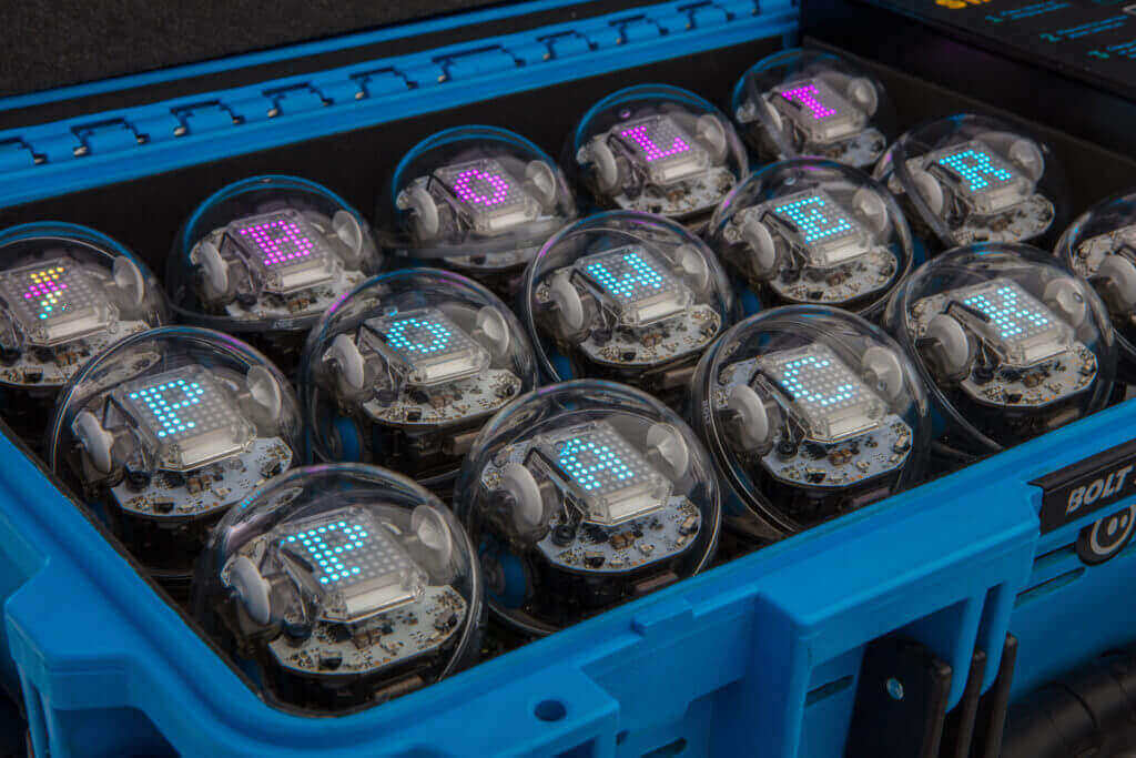 A close-up of a blue case containing multiple robotic devices displaying the word 'POWER' in colorful lights.