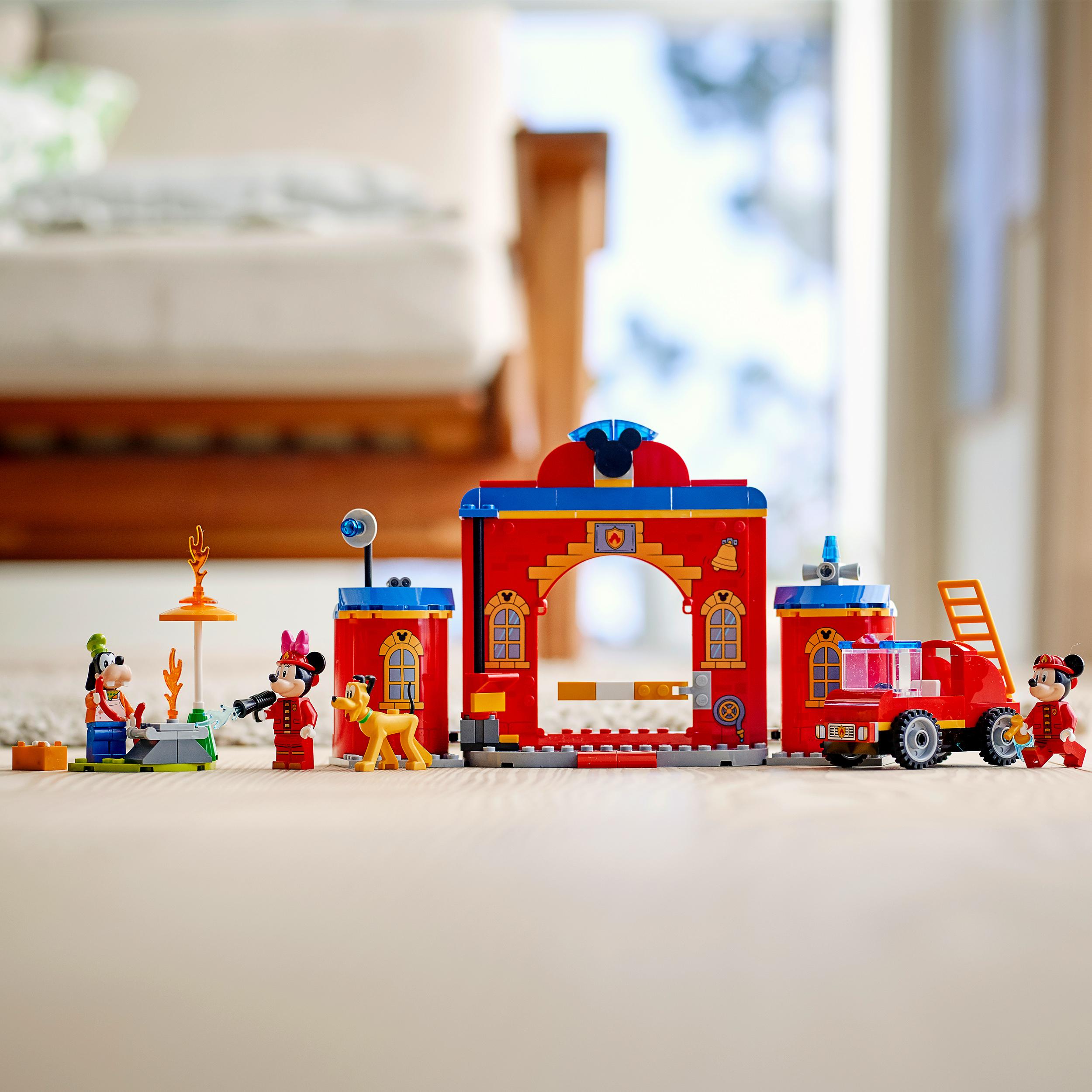LEGO® Disney Mickey Mouse Fire Engine & Station 10776 set with minifigures, dog figure, and fire station on a wooden floor.