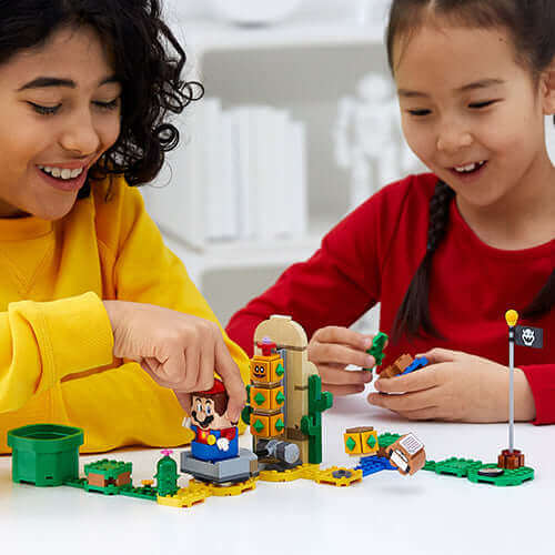 Kids playing with LEGO® Super Mario™ Desert Pokey Expansion Set 71363, enjoying interactive building challenges.