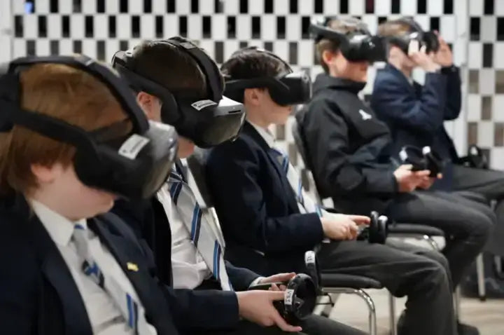 Students experiencing virtual reality in a classroom setting, showcasing immersive technology in education.