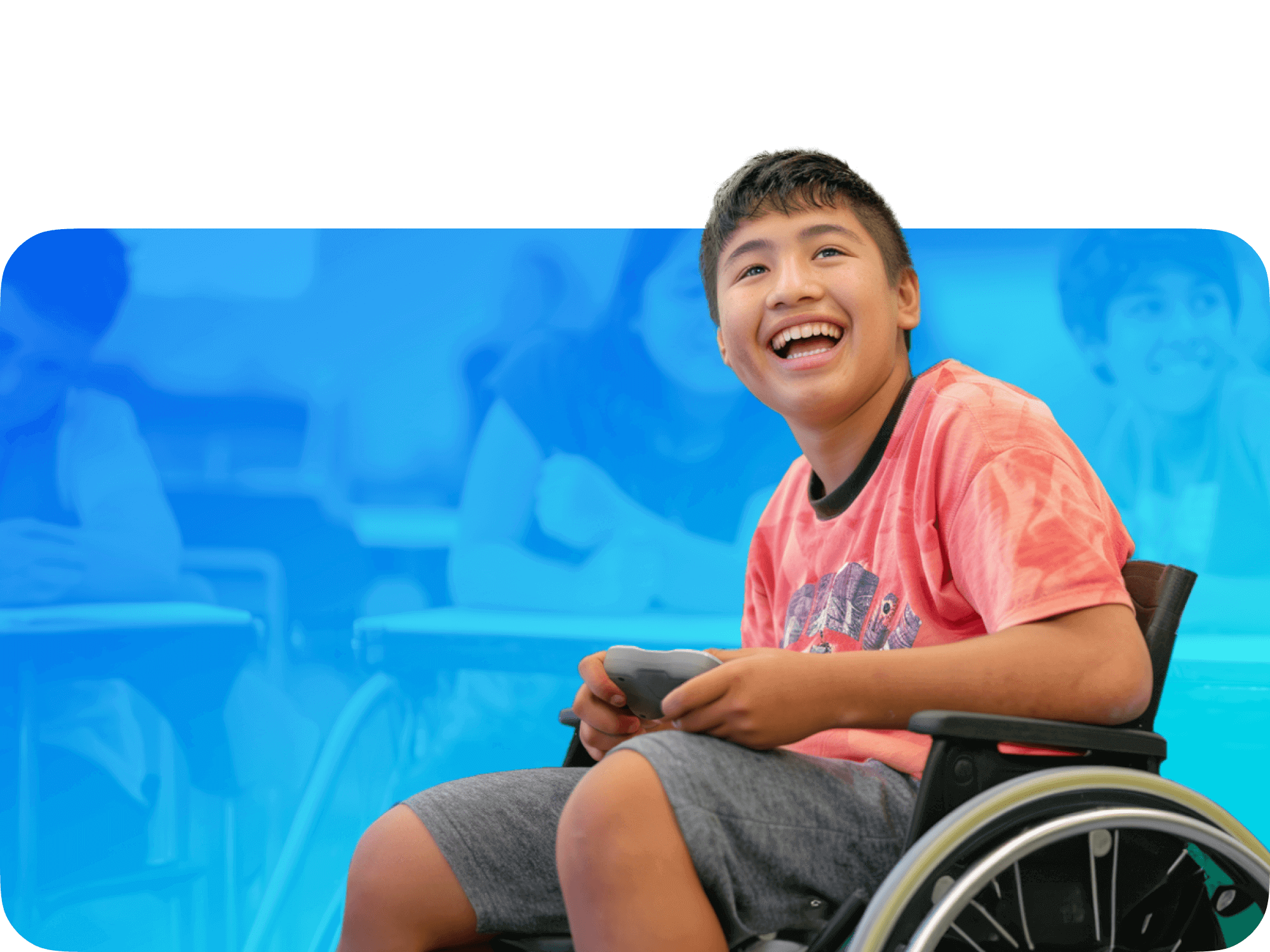 Smiling boy in a wheelchair playing a game, showcasing joy and engagement in a classroom setting.