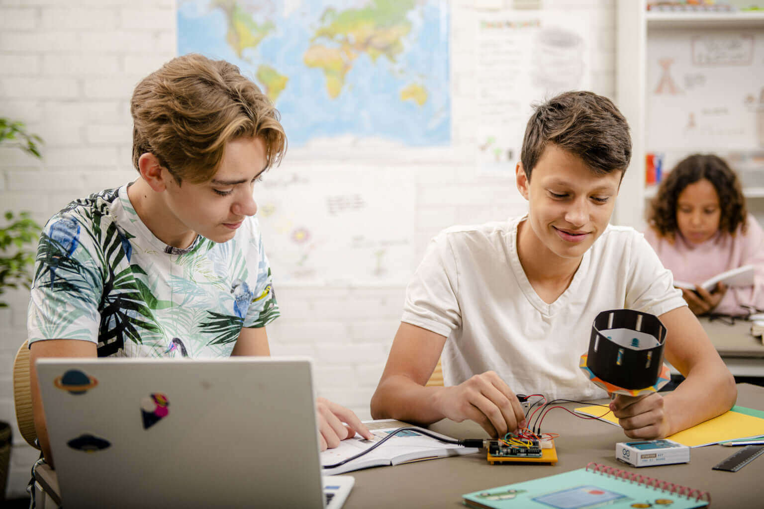 Students engaged in hands-on projects using Arduino Education Starter Kit in a classroom setting.