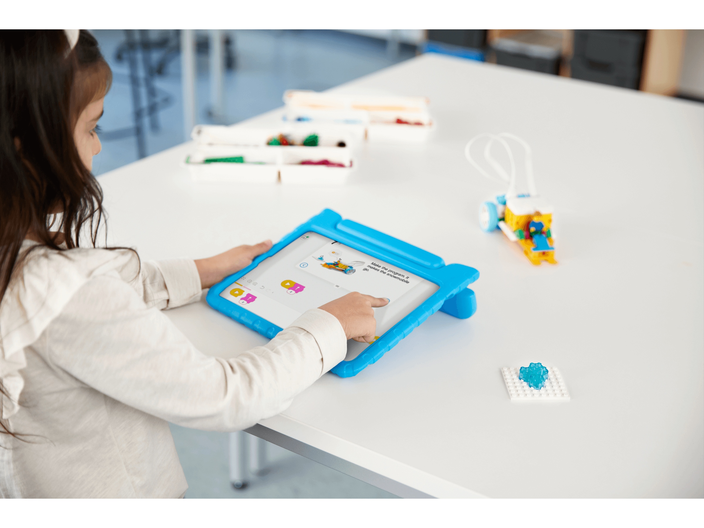 Child using tablet for hands-on STEAM learning with LEGO Education SPIKE Essential Set 45345.