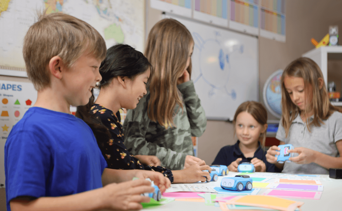 Students engaging with Sphero indi robots, learning STEAM concepts in a classroom setting.