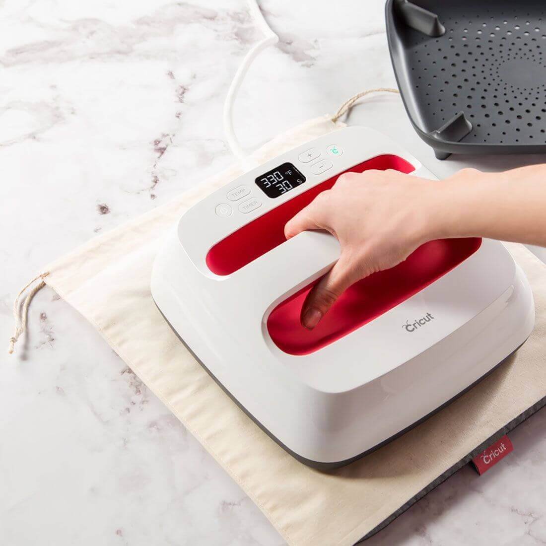 Cricut EasyPress Mat in use with EasyPress machine demonstrating iron-on application.