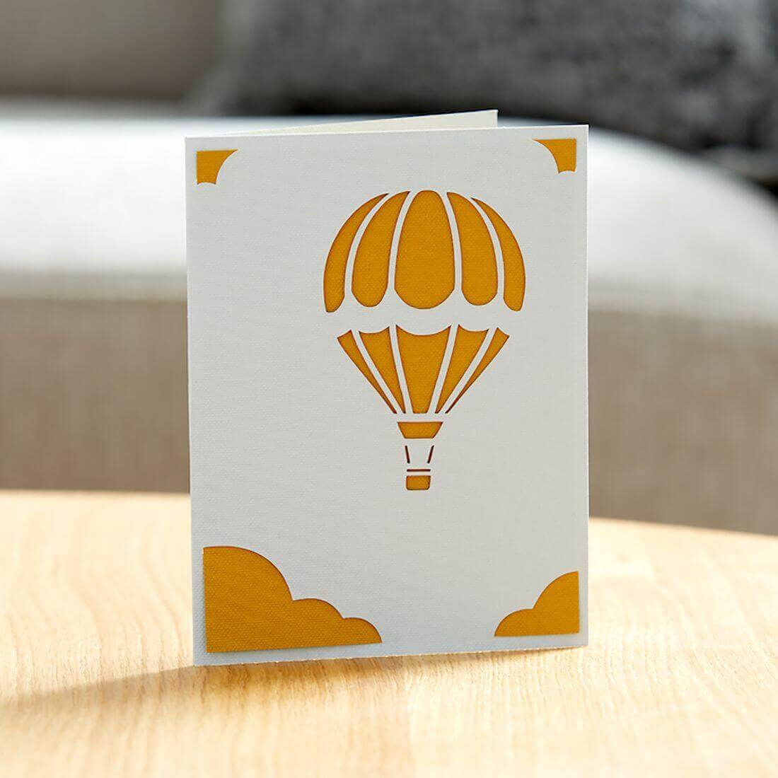 Cricut Joy Insert Card featuring a cut-out hot air balloon design in orange against a white background.