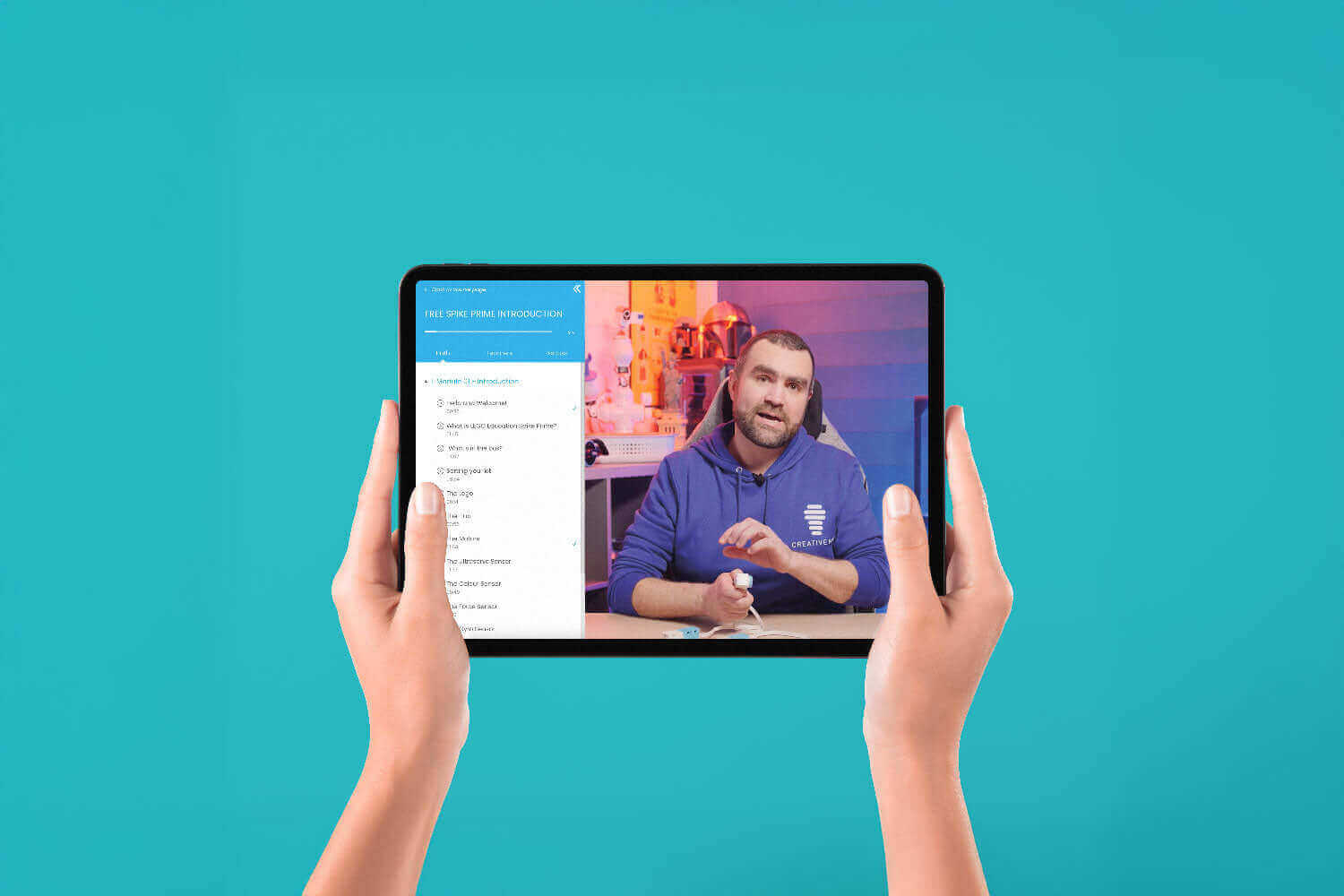 Person holding a tablet displaying a tutorial video on a bright blue background.