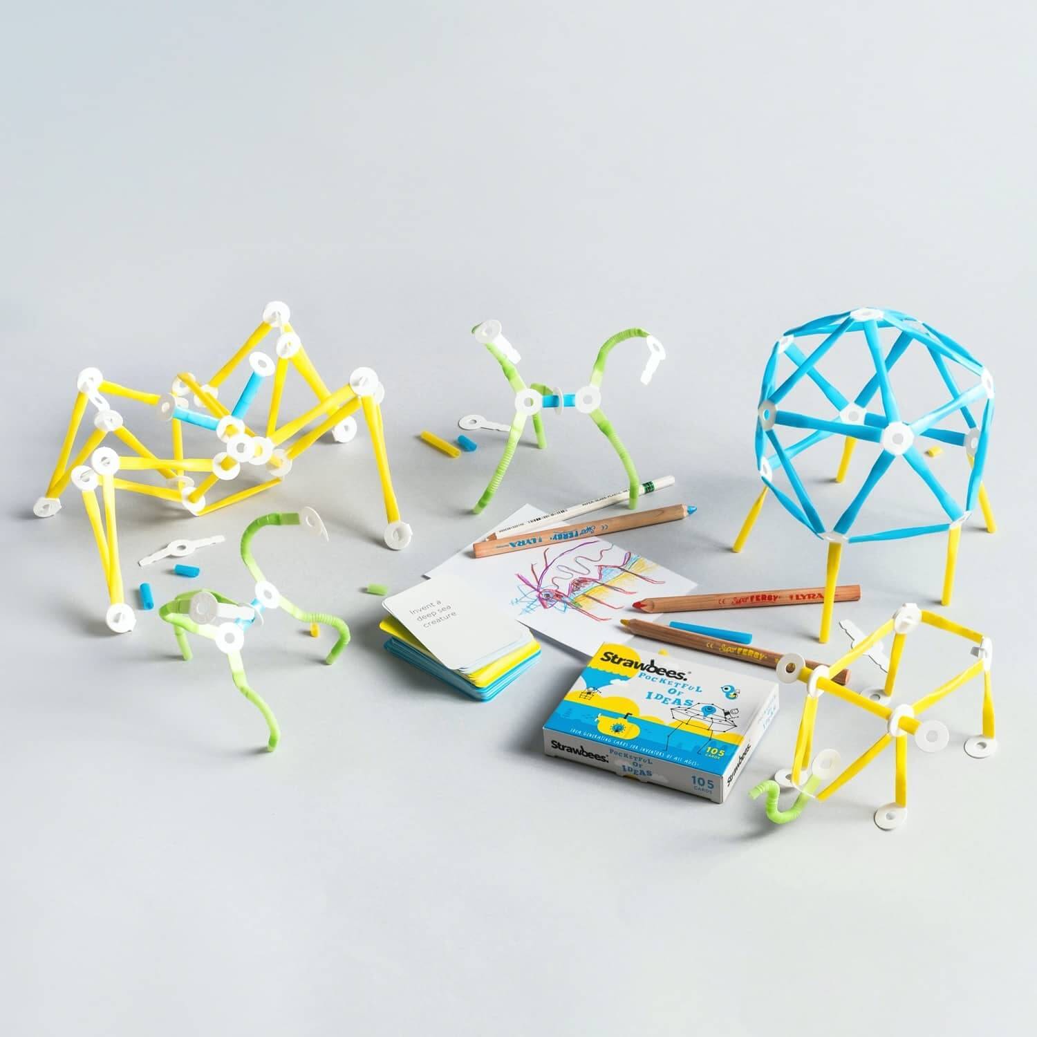 Creative Imagination Kit showcasing structures made from bendable straws and challenge cards for fun learning.