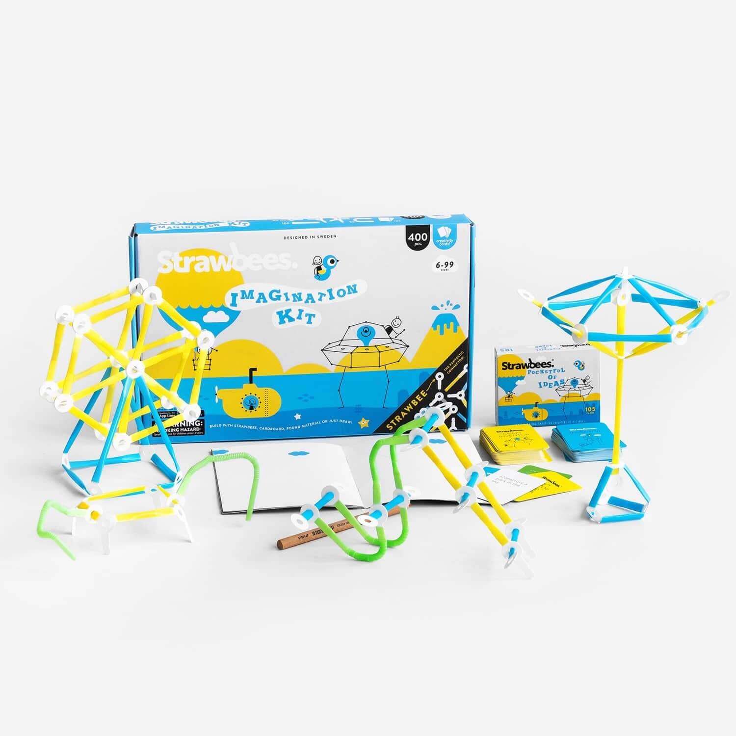 Colorful Imagination Kit with challenge cards, sketchbook, and bendy straws for creative building and storytelling.