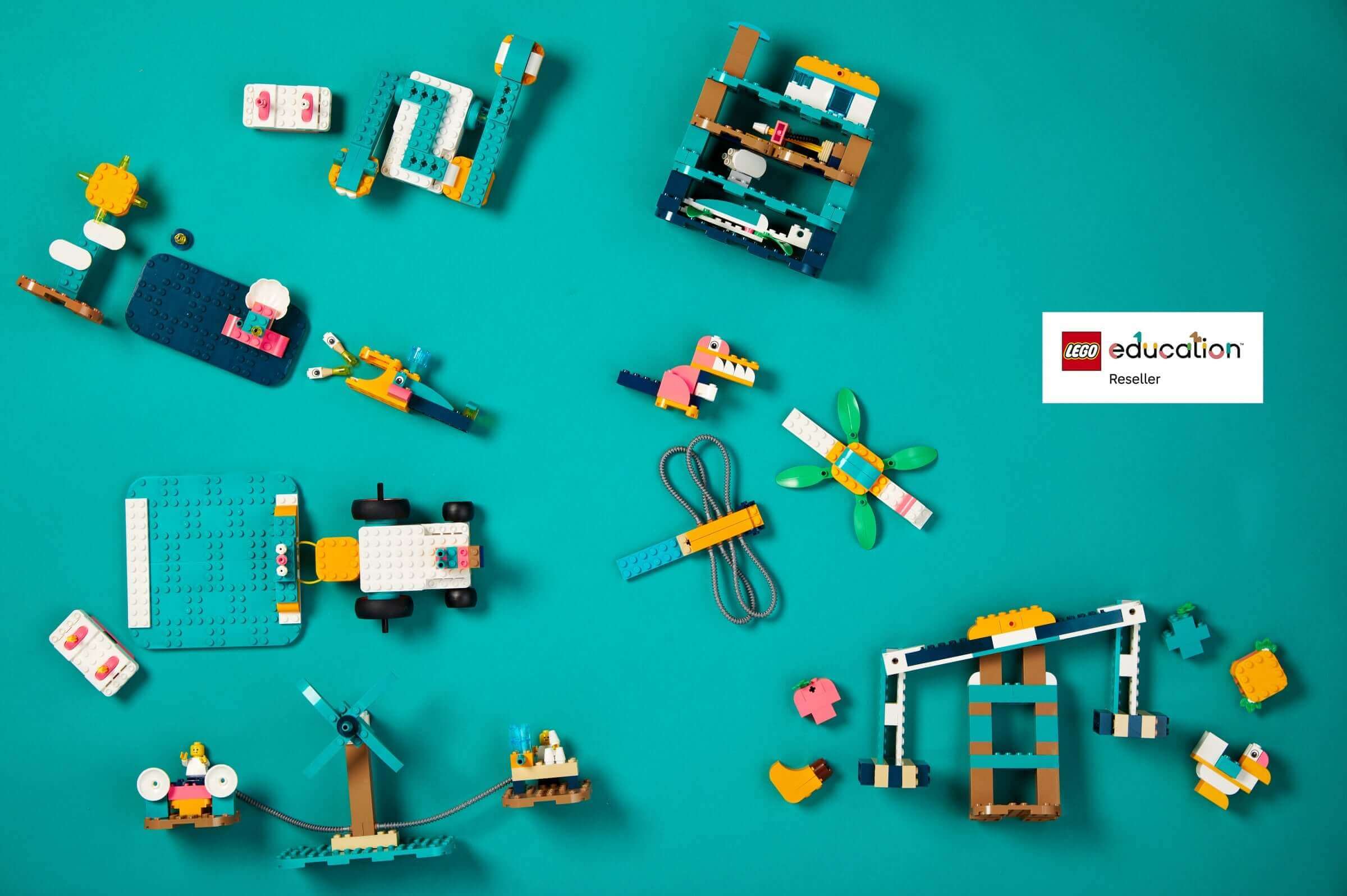 Colorful LEGO Education sets arranged on a teal background, showcasing creativity and learning through play.