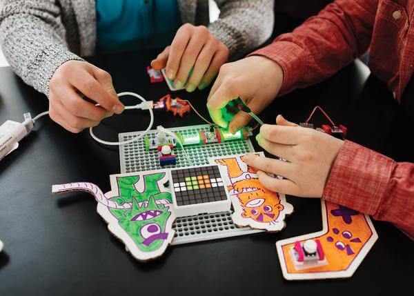 Students building and coding with the littleBits Code Kit, showcasing creativity and engineering concepts.