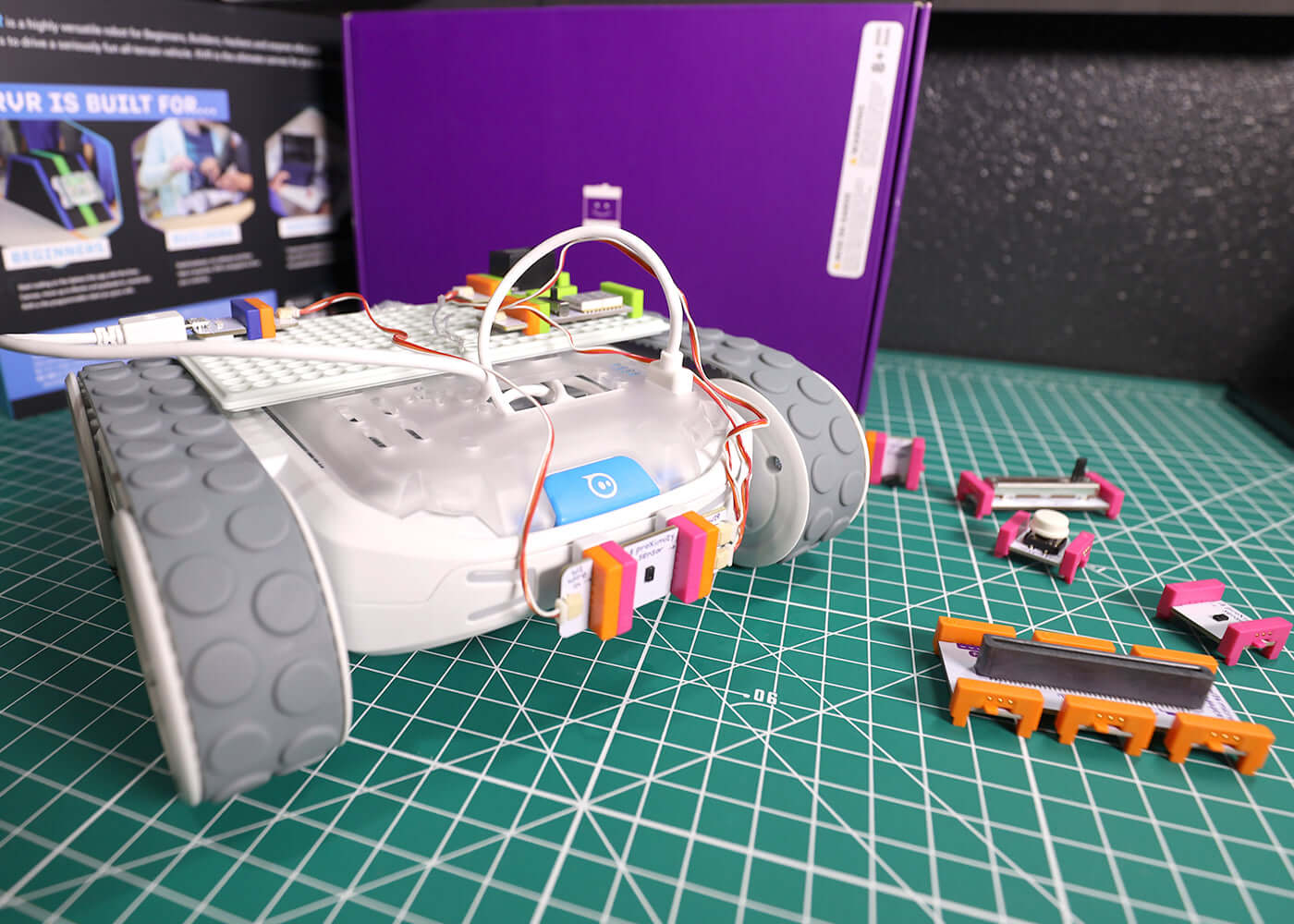 Sphero RVR with littleBits Topper Kit, showcasing modular components and mechanical parts on a cutting mat.