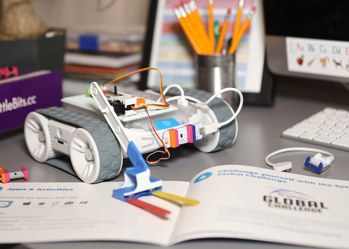 littleBits RVR+ Topper Kit with mechanical arm on a work desk, showcasing creativity and invention.