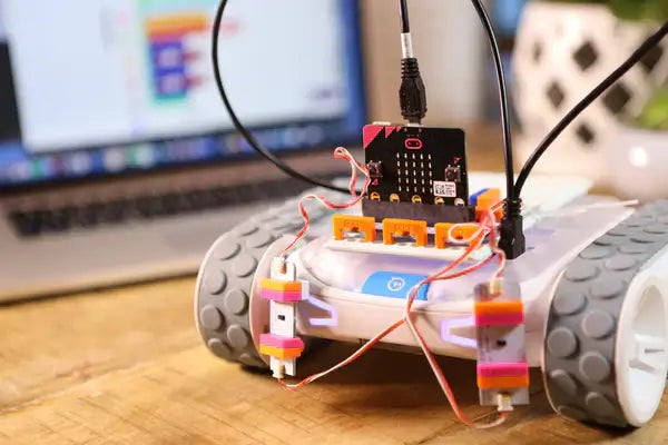 littleBits micro:bit Adapter connected to a robot with coding interface in the background for creative learning.