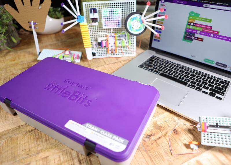 littleBits STEAM+ Coding Kit with purple storage box, electronics components, and computer coding interface on desk.