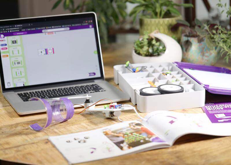LittleBits STEAM+ Coding Kit on a table with laptop, instruction manual, and components for hands-on learning.