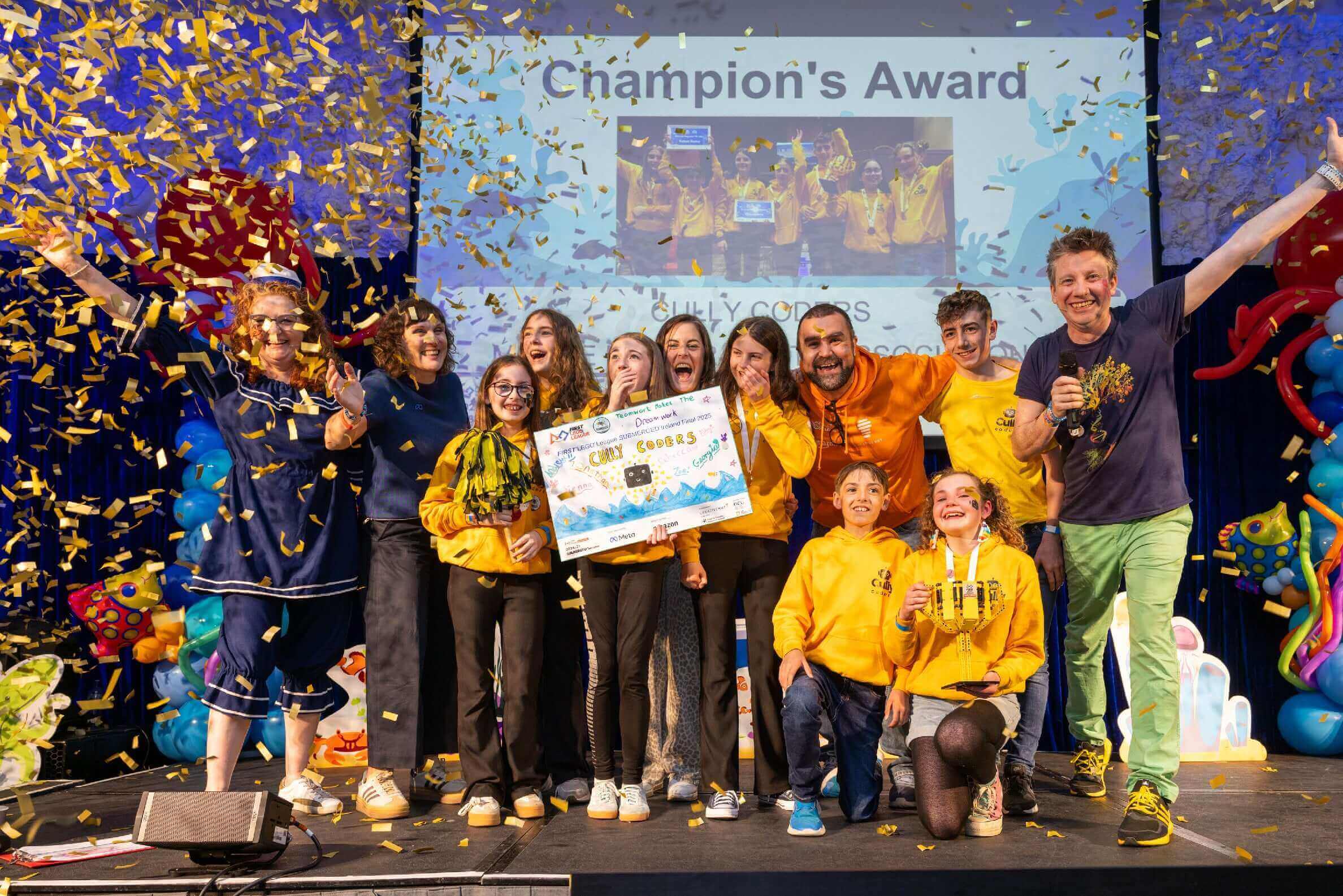 Celebration of winners receiving the Champion's Award with confetti and colorful balloons at an event.
