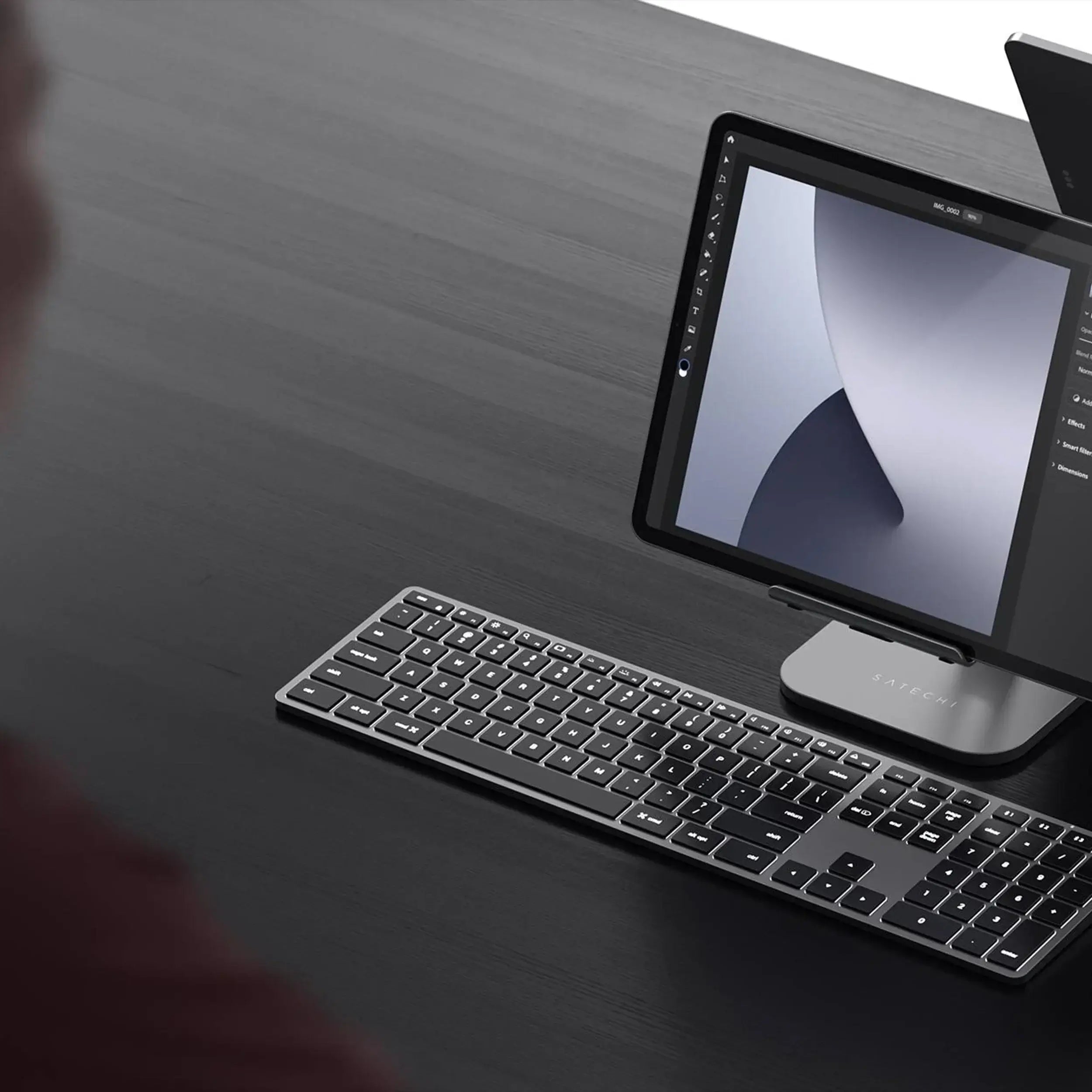 Satechi Slim Backlit Keyboard for Mac with tablet on a modern desk, showcasing sleek design and functionality.