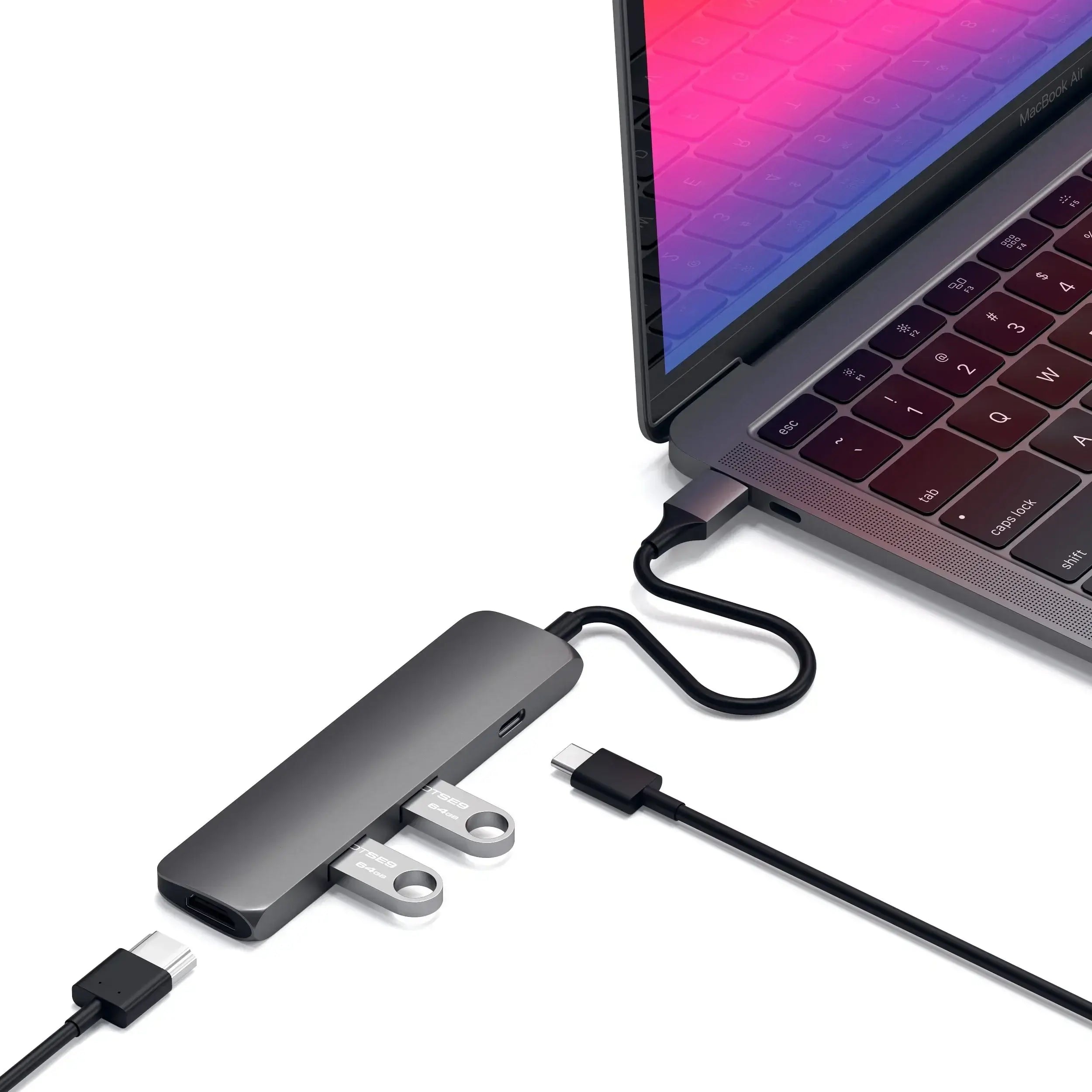 Satechi Type-C Slim Multi-Port Adapter connected to MacBook, showcasing USB ports and HDMI output.