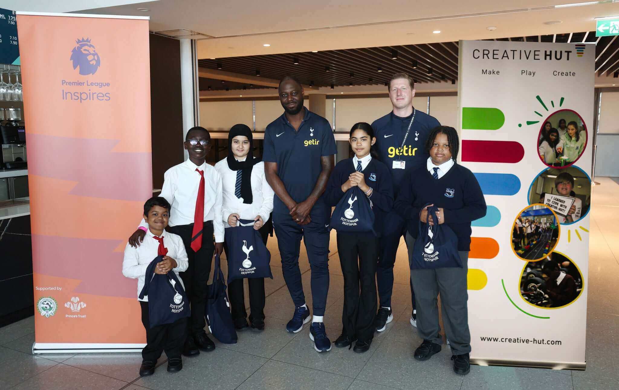 Group photo of children and mentors at Premier Language Inspires event with Getir and Creative Hut banners.