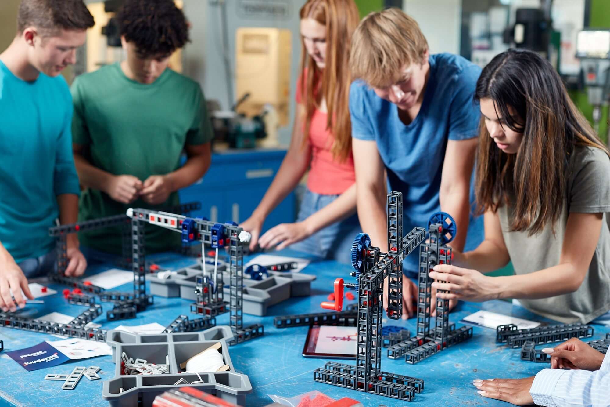 Students collaborating on engineering projects with Sphero Blueprint Build Class Pack parts in a classroom setting.