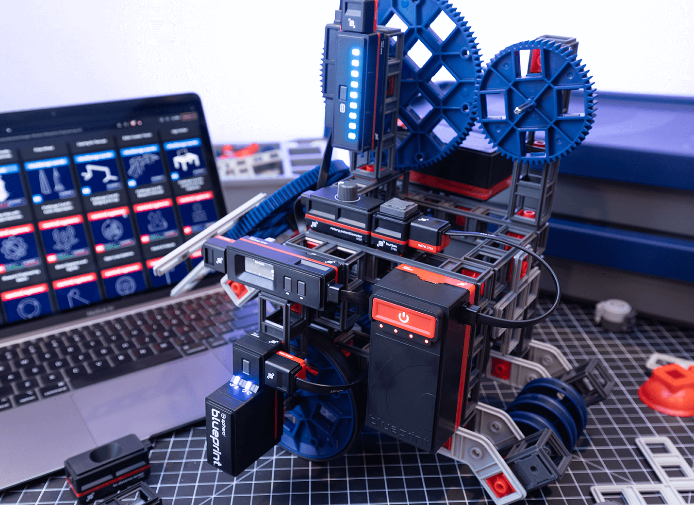 Sphero Blueprint Engineering Kit with motors, sensors, and a laptop displaying engineering designs for learners.