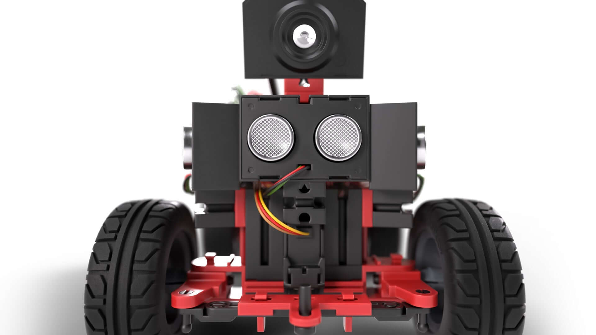Close-up of a robot's front view showcasing sensors and wheels for STEM coding competitions.