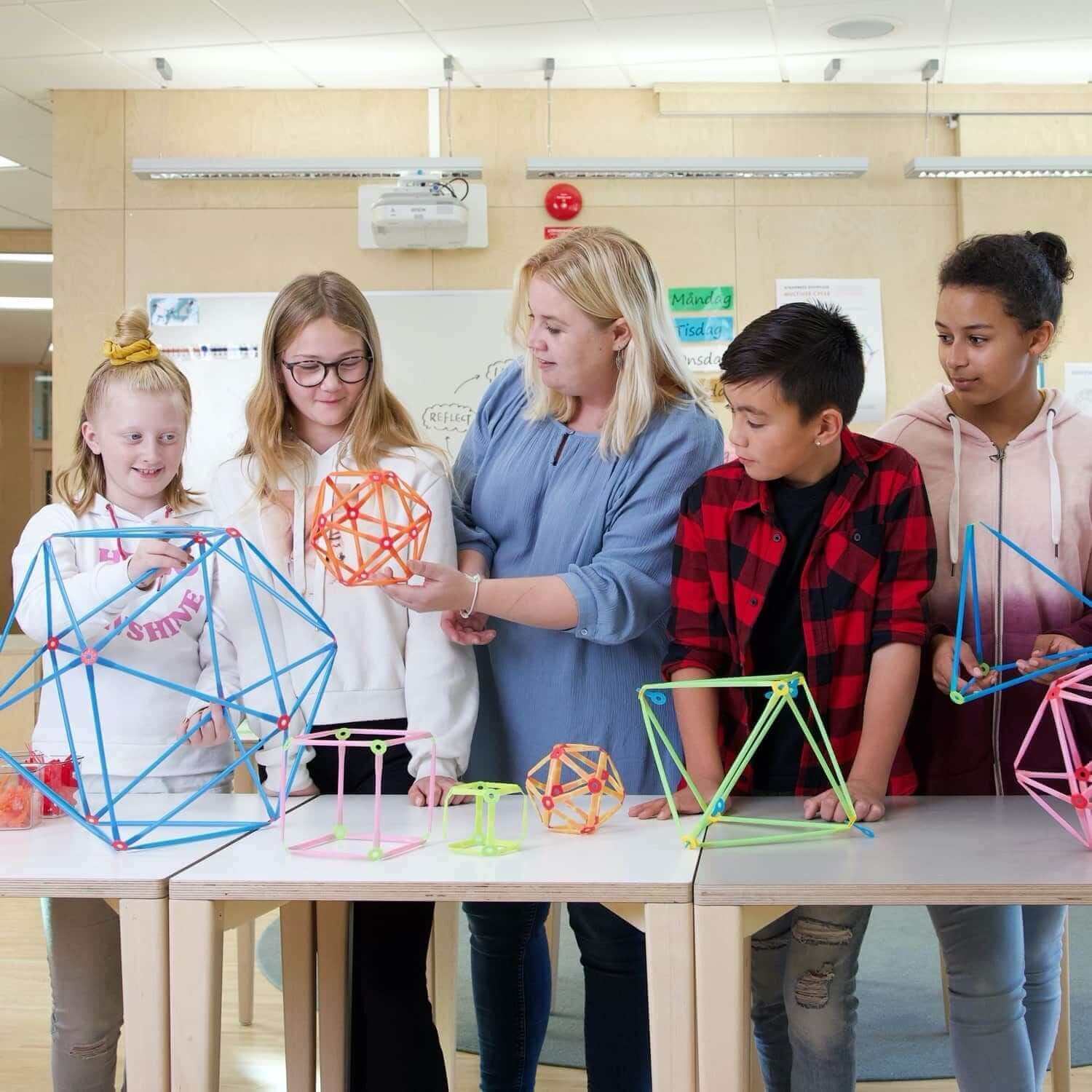 Students engaging with Strawbees STEAM School Kit, showcasing colorful geometric structures and collaborative learning.