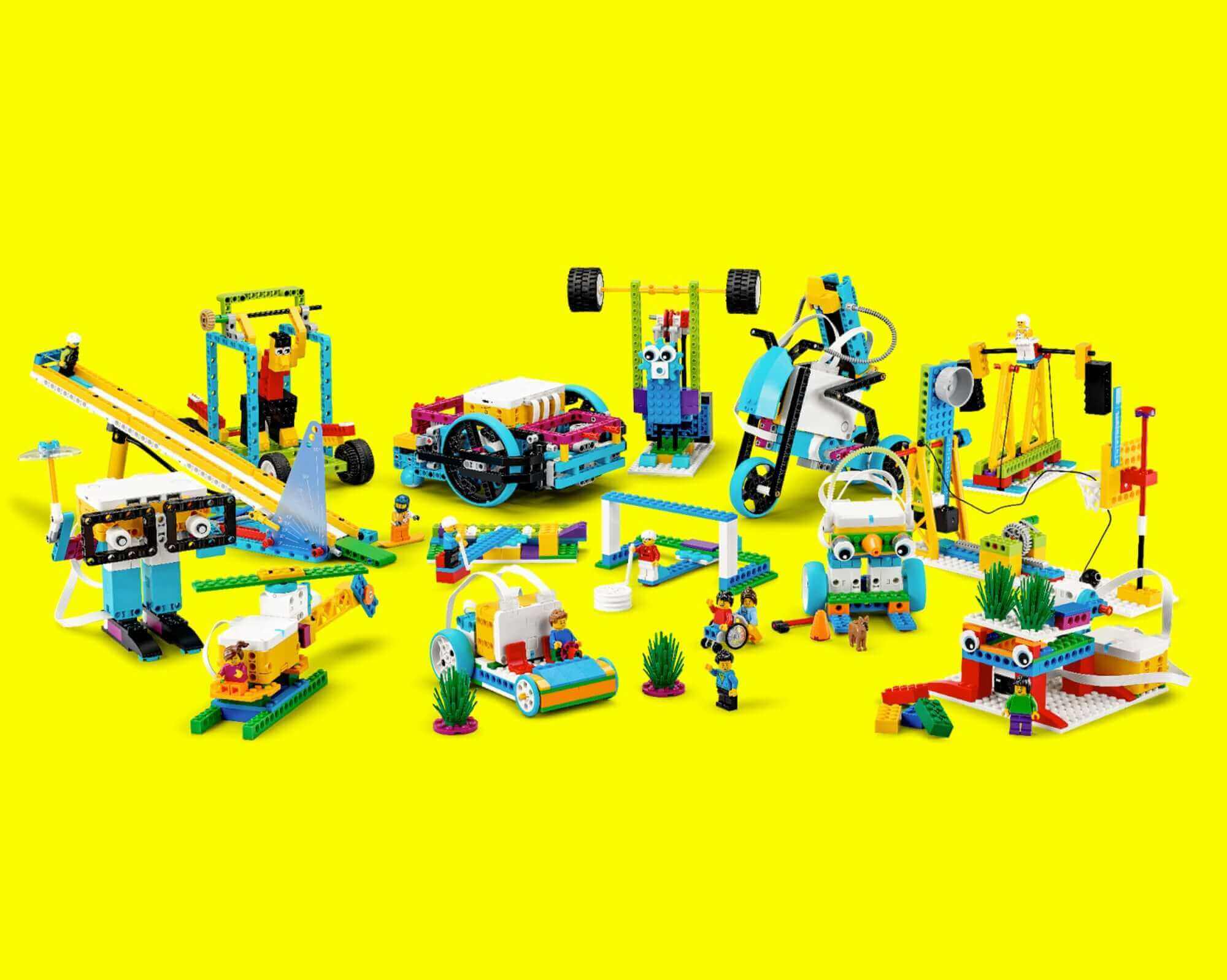 Colorful LEGO creations including vehicles and construction scenes against a bright yellow background.