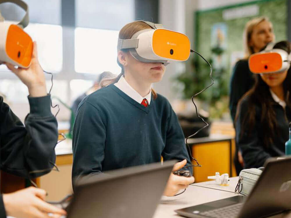 Students wearing VR headsets in a classroom, engaged in immersive learning and technology.