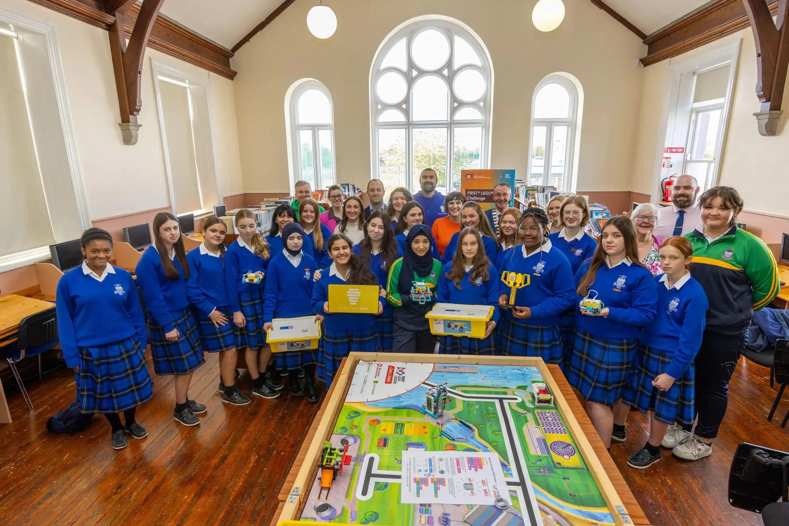 Students from Meath schools gather with robotics kits, showcasing STEAM education initiatives in a bright classroom.