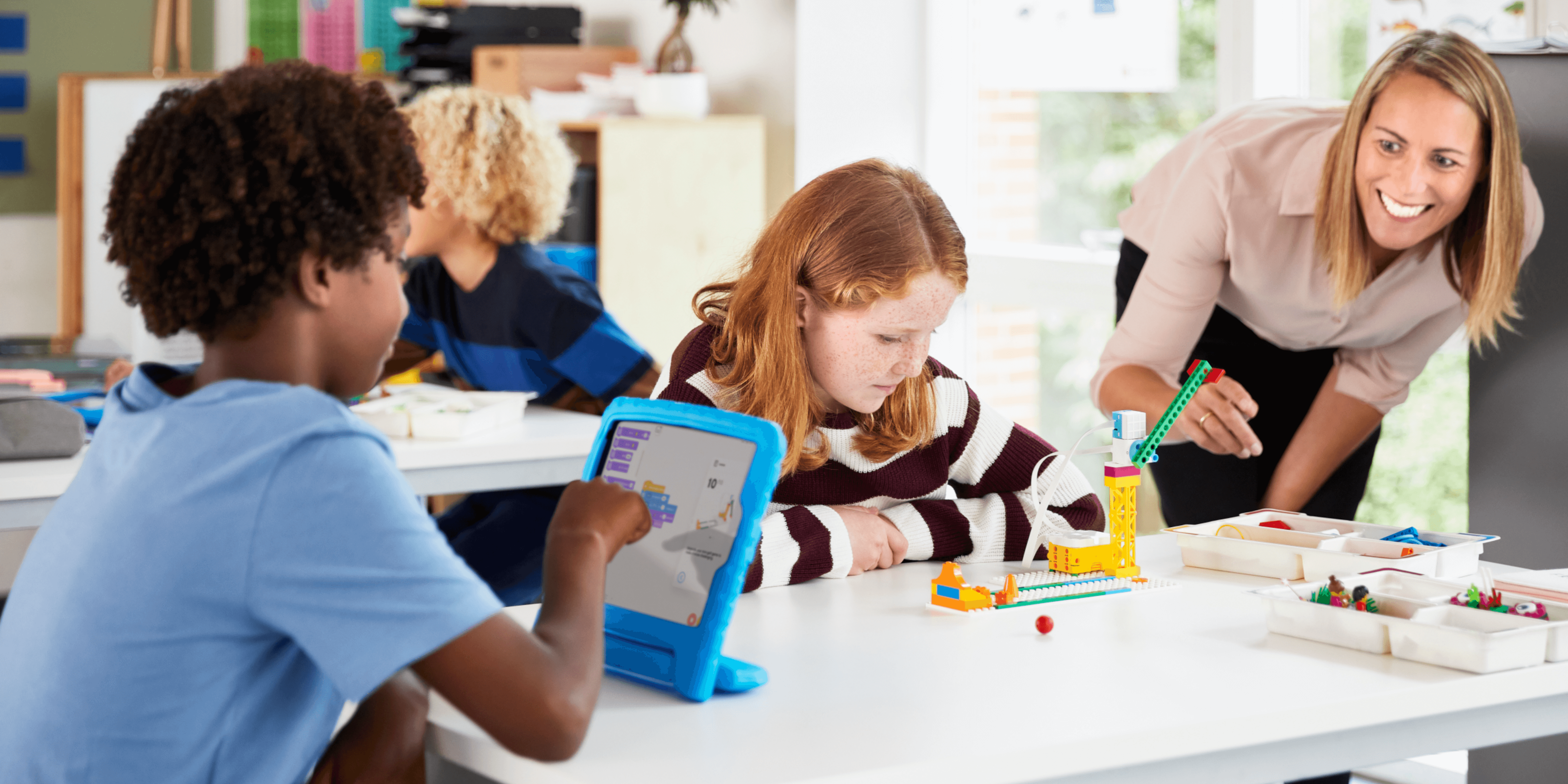 Students learning coding skills in a classroom setting demonstrating the importance of education.