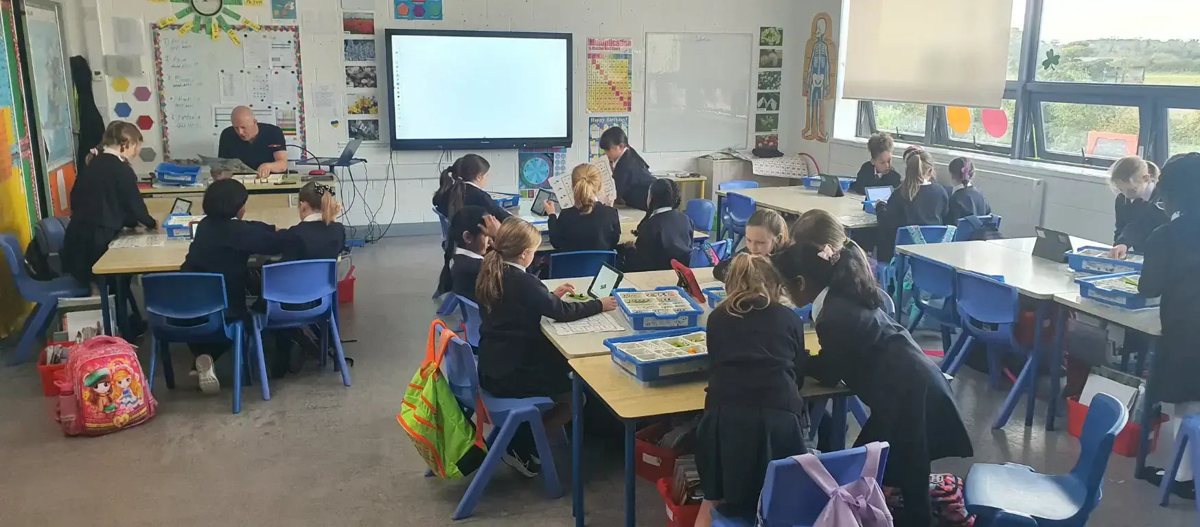 Students engaged in creative learning activities during a workshop at Réalt na Mara Girls National School.