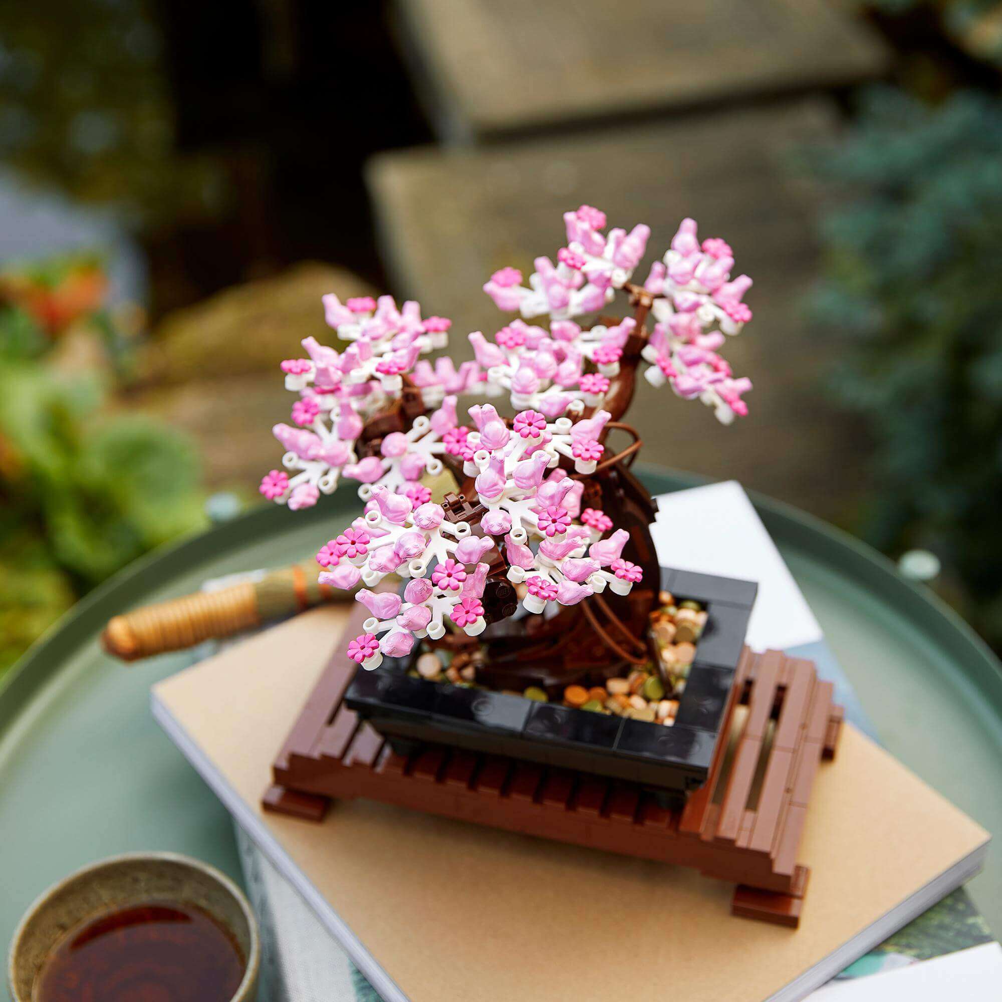 LEGO® Bonsai Tree Building Set 10281 with pink cherry blossoms on a decorative base, perfect for hobbyists.