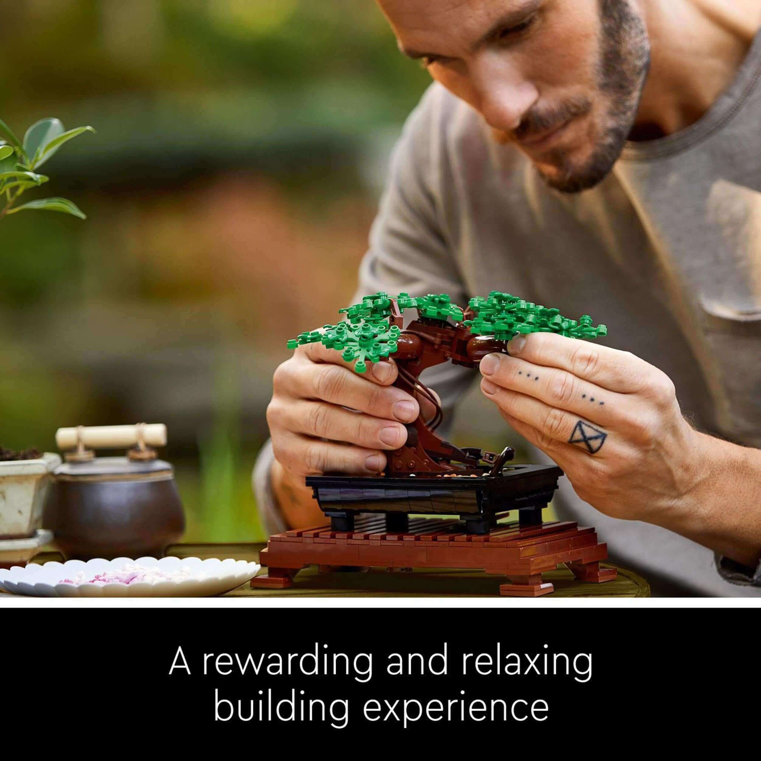 Man builds LEGO® Bonsai Tree model, showcasing a rewarding and relaxing creative experience.