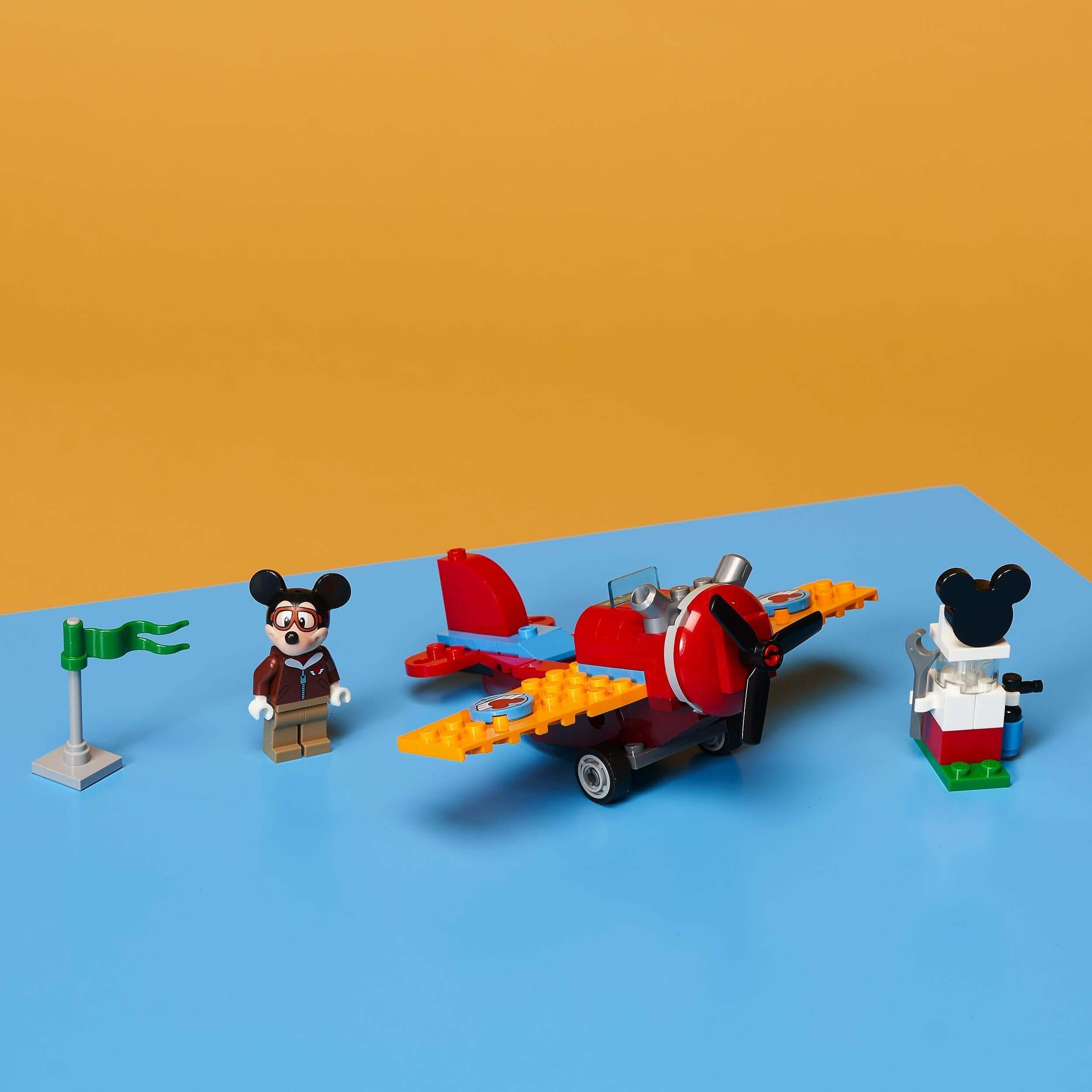 LEGO Disney Mickey Mouse & Friends Plane Set 10772 with minifigure, tool cart, and propeller plane against a bright background.