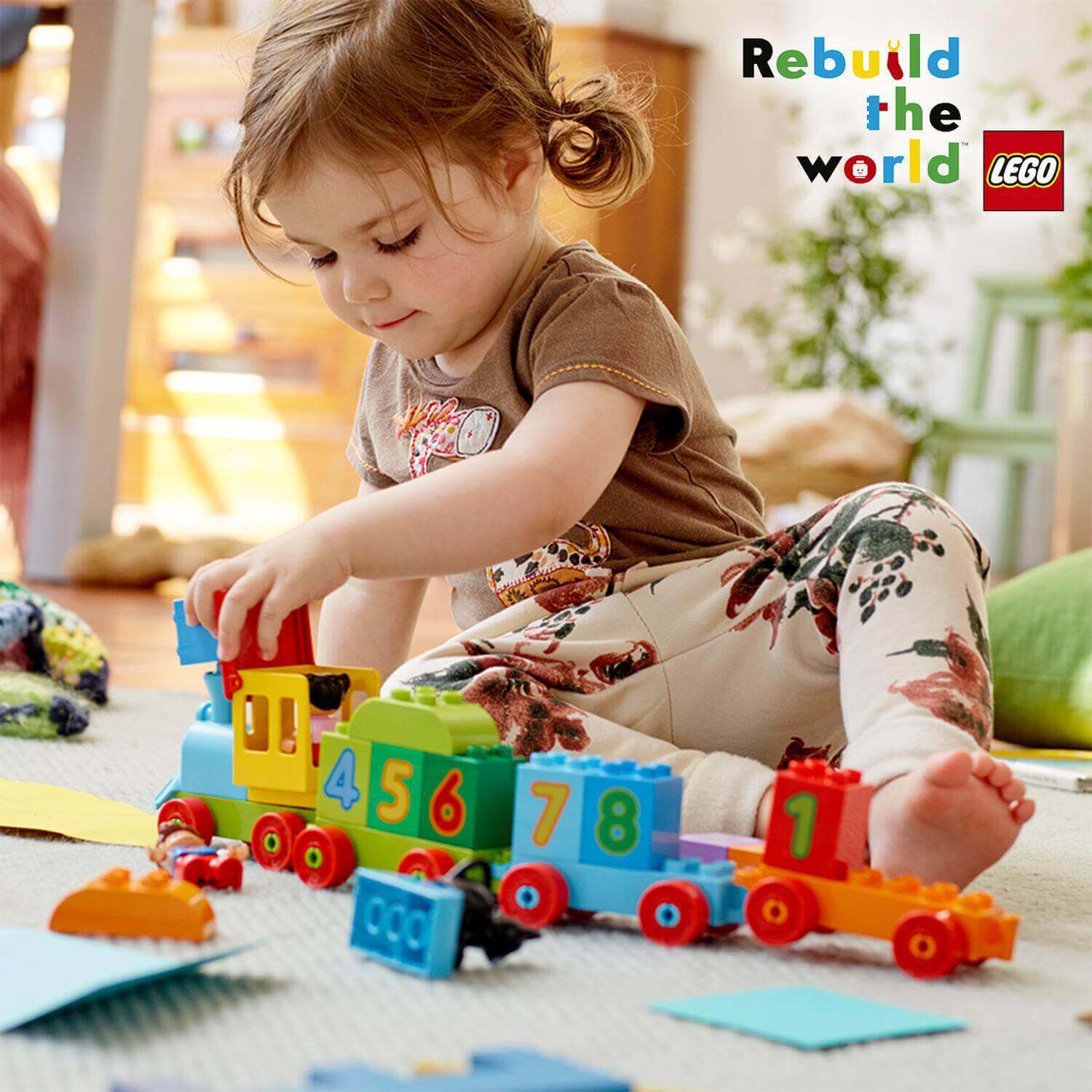 Child playing with LEGO® DUPLO Number Train set 10847, enhancing early number recognition and counting skills.