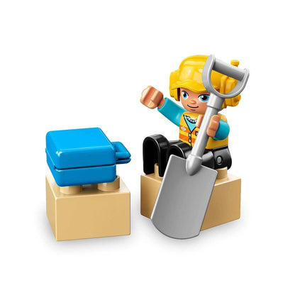 LEGO DUPLO construction worker figure with shovel, interacting with building blocks in playful setting.