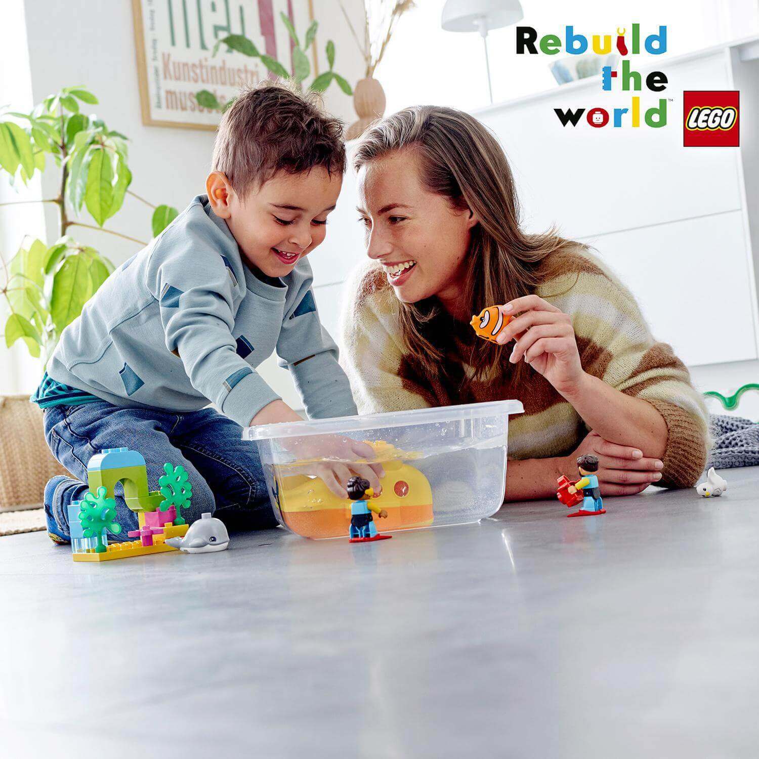 Mom and son enjoying LEGO® DUPLO Town Submarine Adventure bath toy, fostering learning and fun at bathtime.
