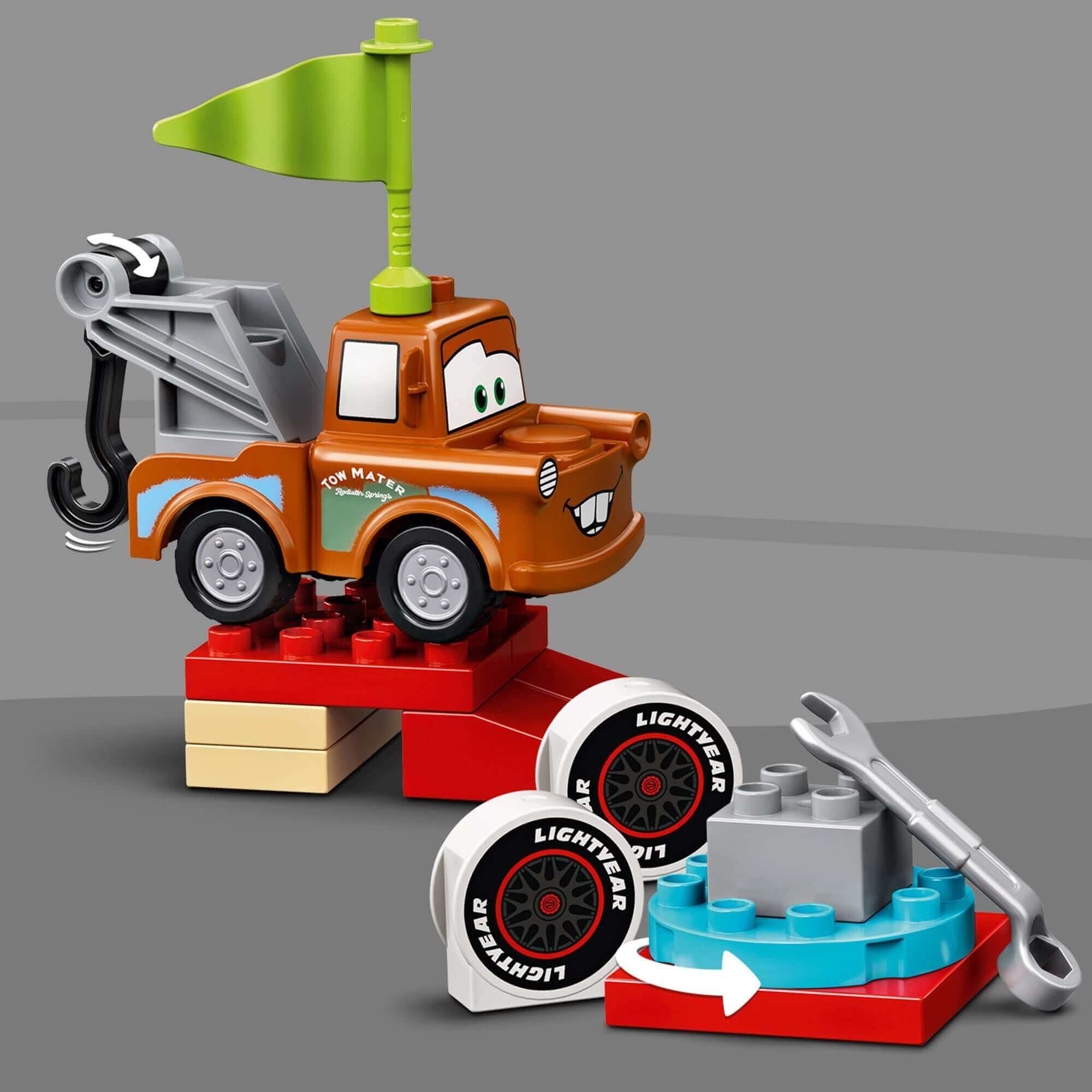 LEGO DUPLO Cars Lightning McQueen Race Day Set with Toy Mater and race tires for toddlers' imaginative play.