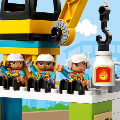 LEGO DUPLO Town Tower Crane set with three construction worker figurines at a busy construction site.