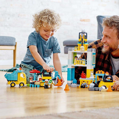 Child and adult playing with LEGO® DUPLO Town Tower Crane & Construction Set 10933, exploring creative construction activities.